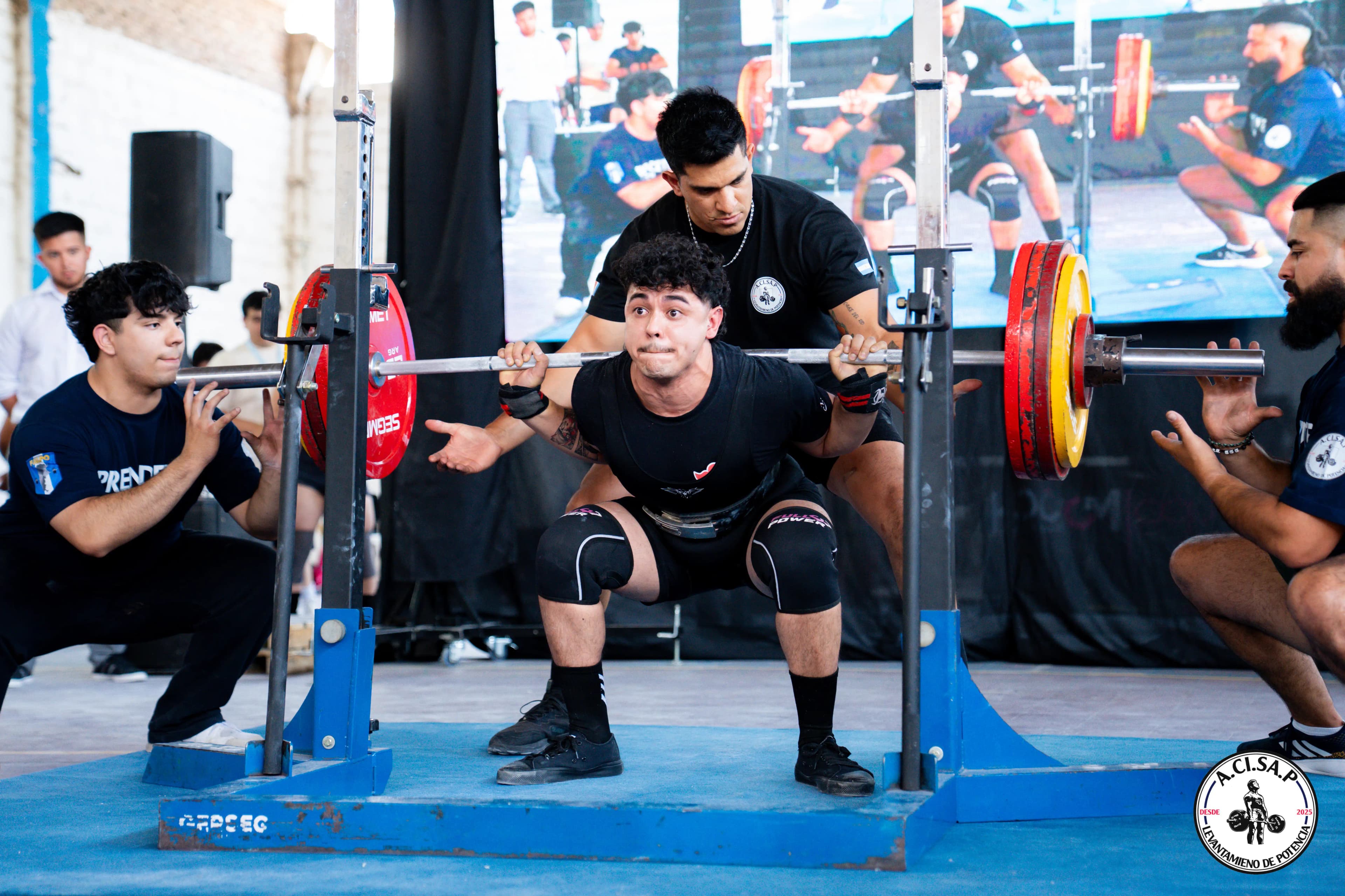 Atleta realizando sentadilla en una competición de ACISAP